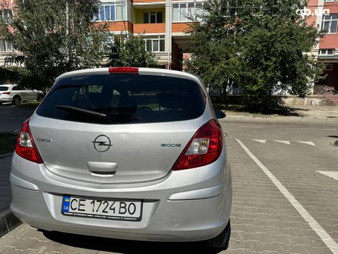 Opel Corsa 2011 серебристый - фото 8